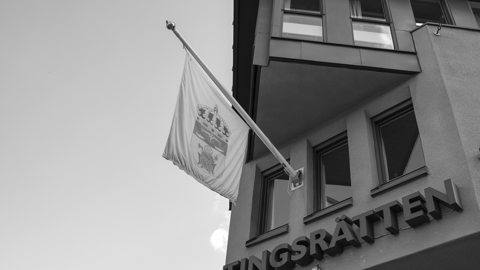 Tingsrättsbyggnad med flagga.