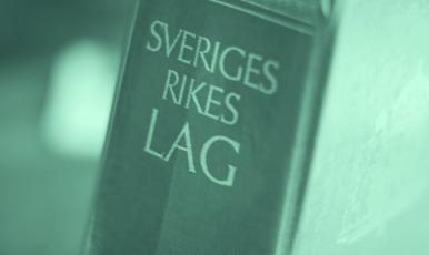 Lagbokens rygg där texten Sveriges rikes lag står skrivet.